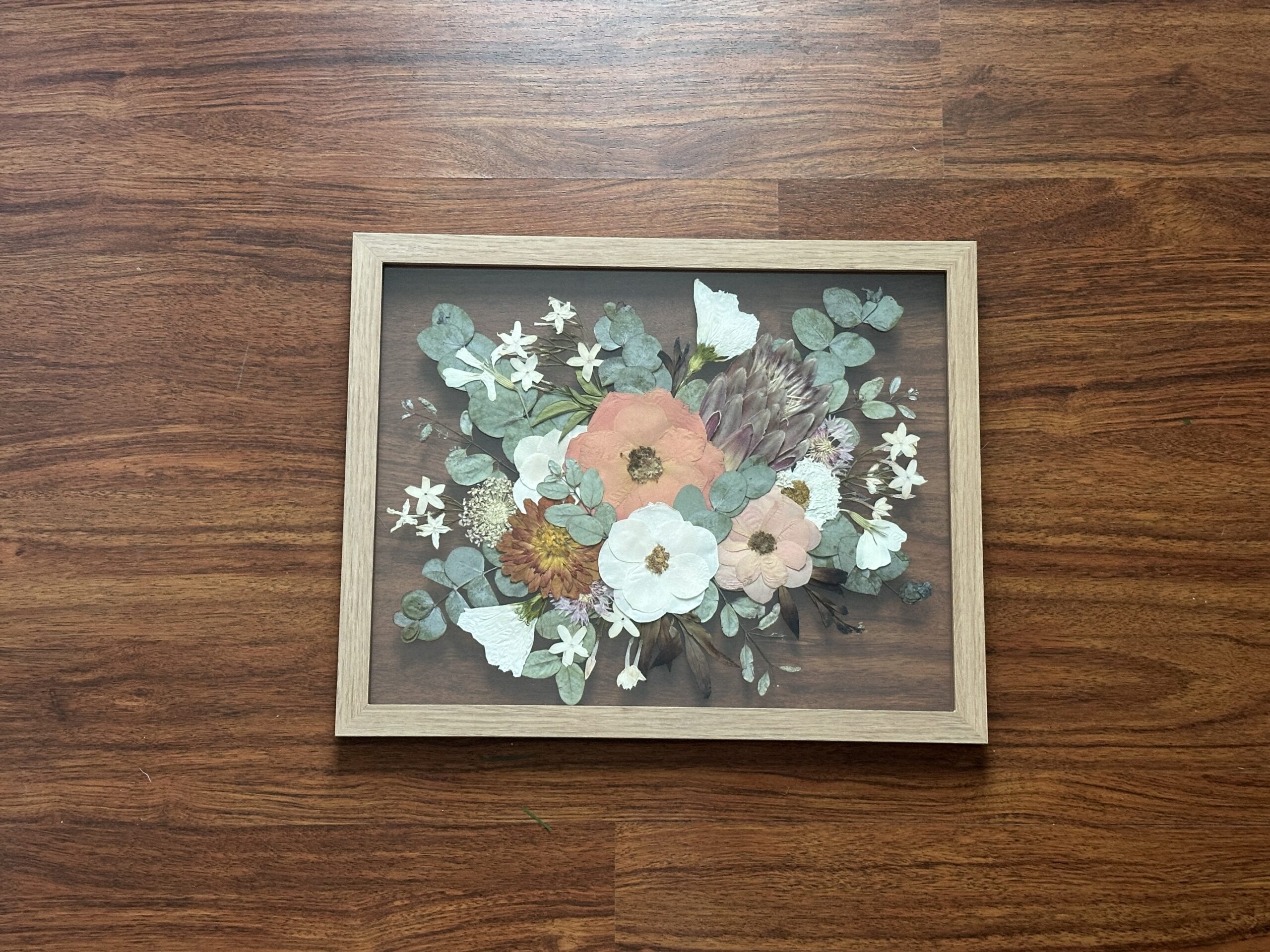 Layflat Photo of a picture frame with pressed flowers -