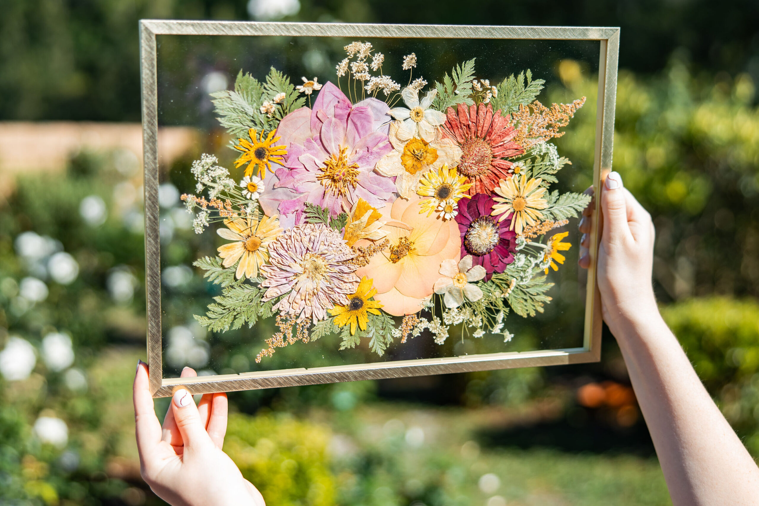 pressed flower frame in 11x14 gold float style featured in a garden