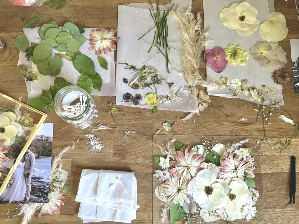 pressed flower art including scattered petals, q tips, and glue