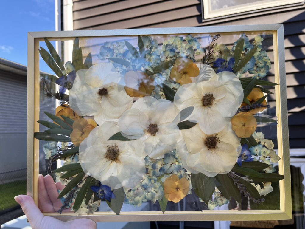 pressed flowers in a gold frame