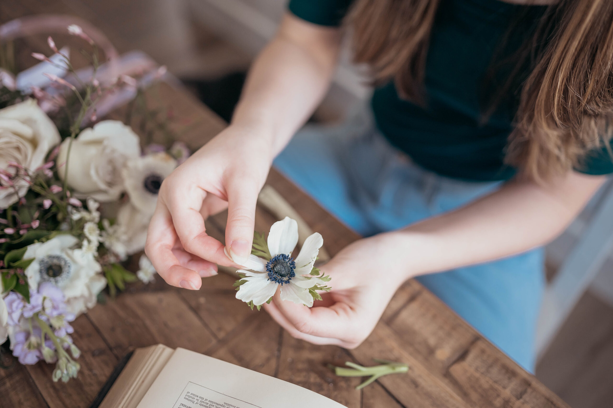 artist pressing a bridal bouquet into a book