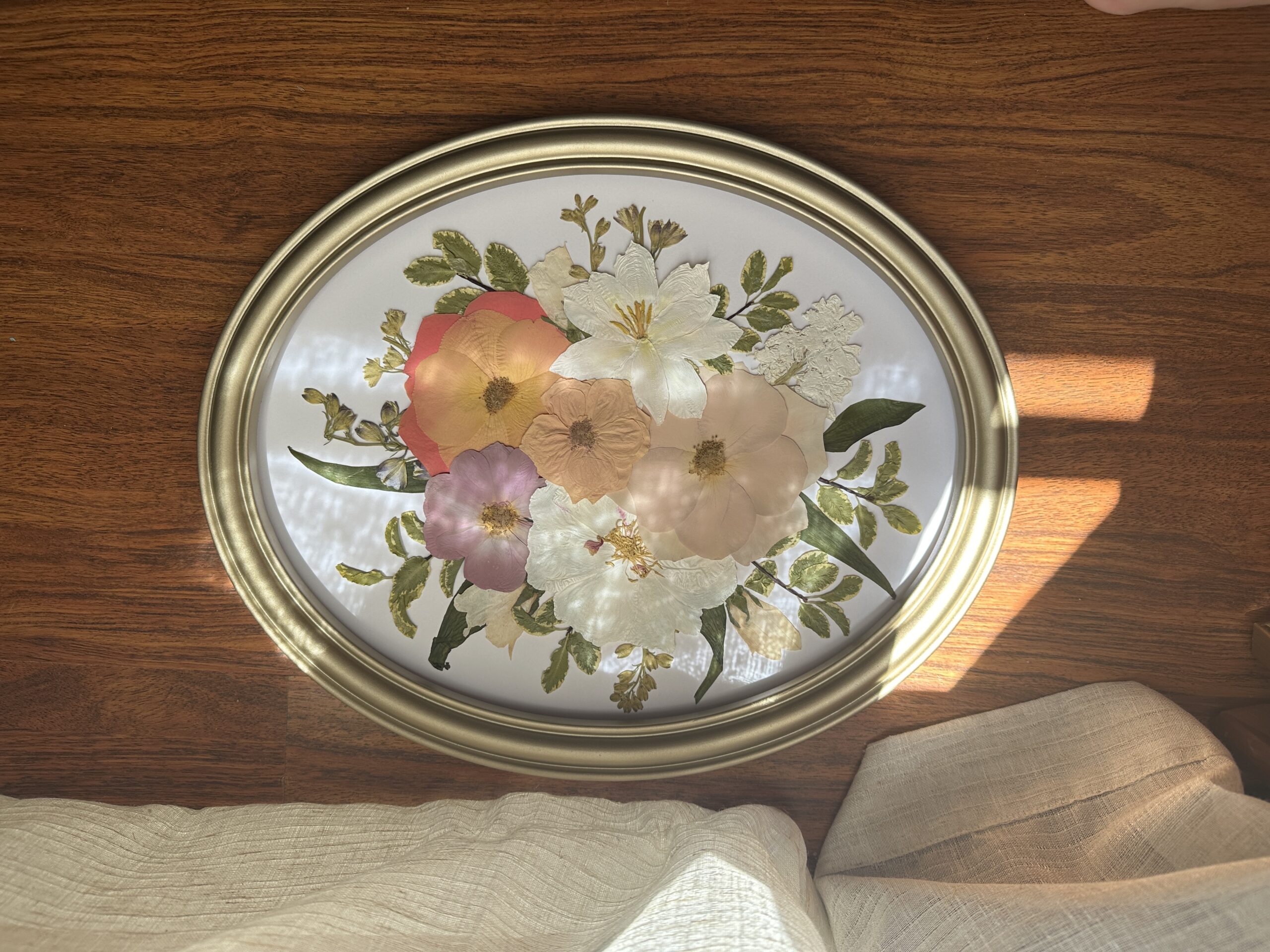 Pressed flowers in oval frame